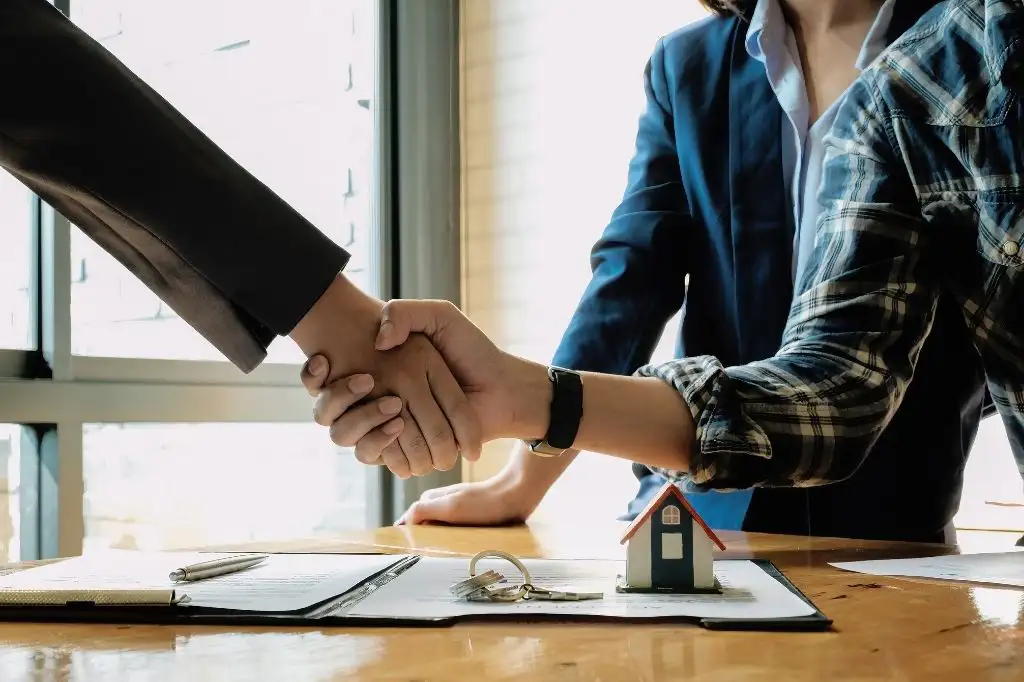 Real estate broker in the Philippines closing a successful property deal with clients.
